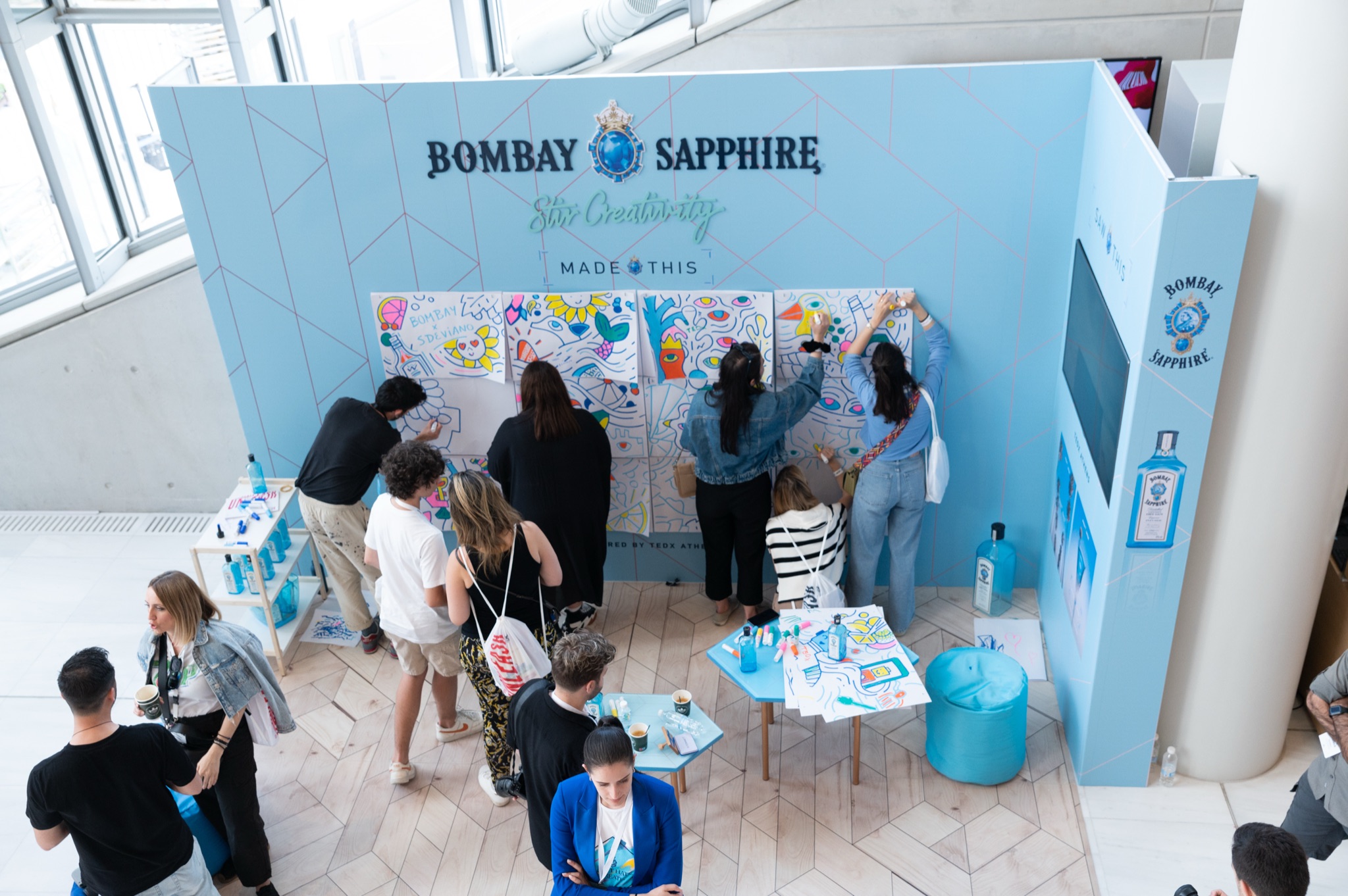 The stand, mid-afternoon — artist at the board, audience filling in