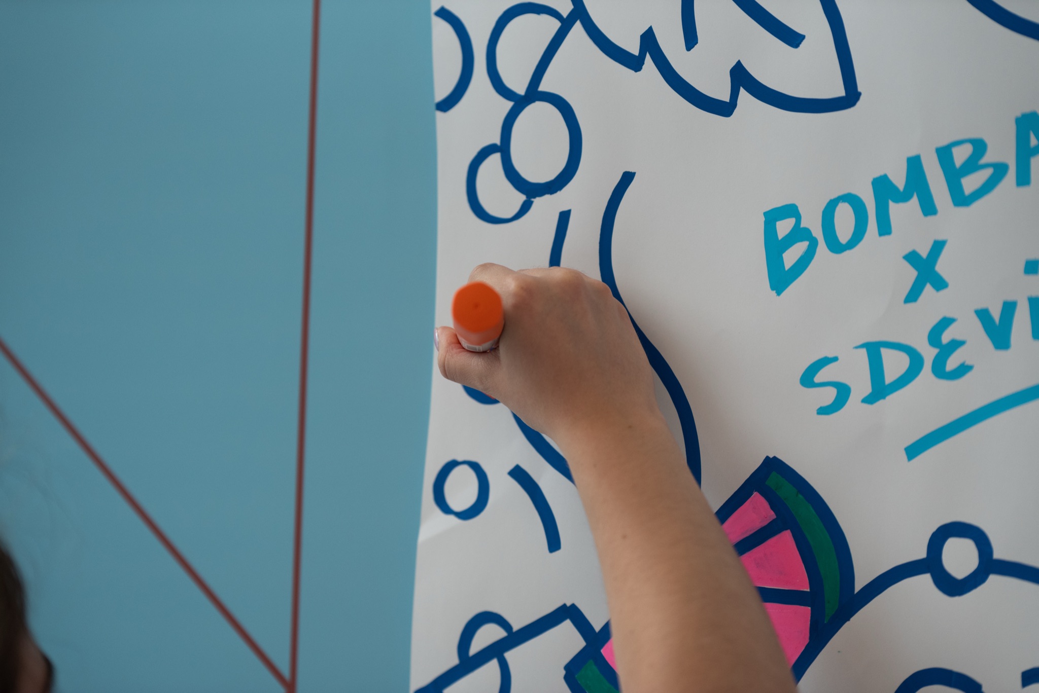 Bombay x SDeviano — an attendee adding colour to a finished sheet