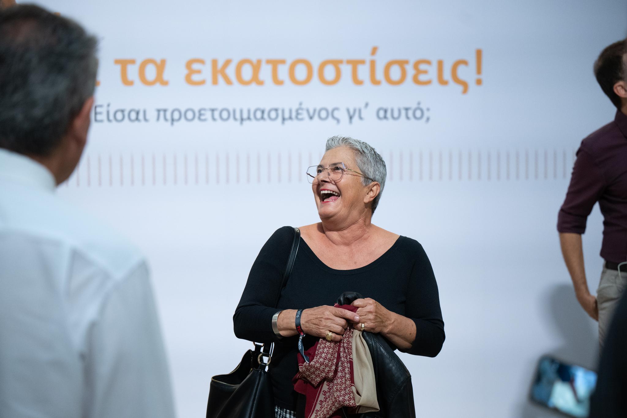 The booth lit, Cacoyannis Foundation foyer, guests in frame