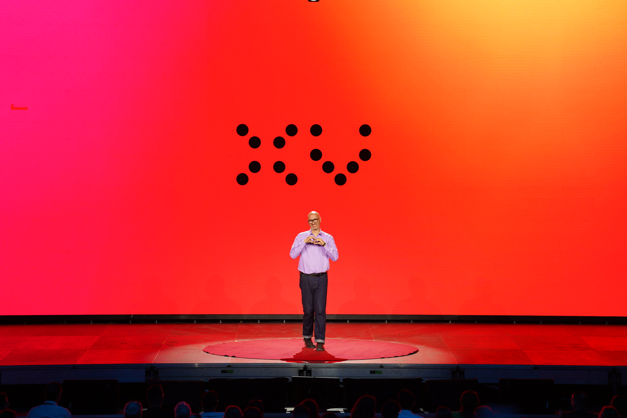 Speaker on the red circle, house in darkness behind